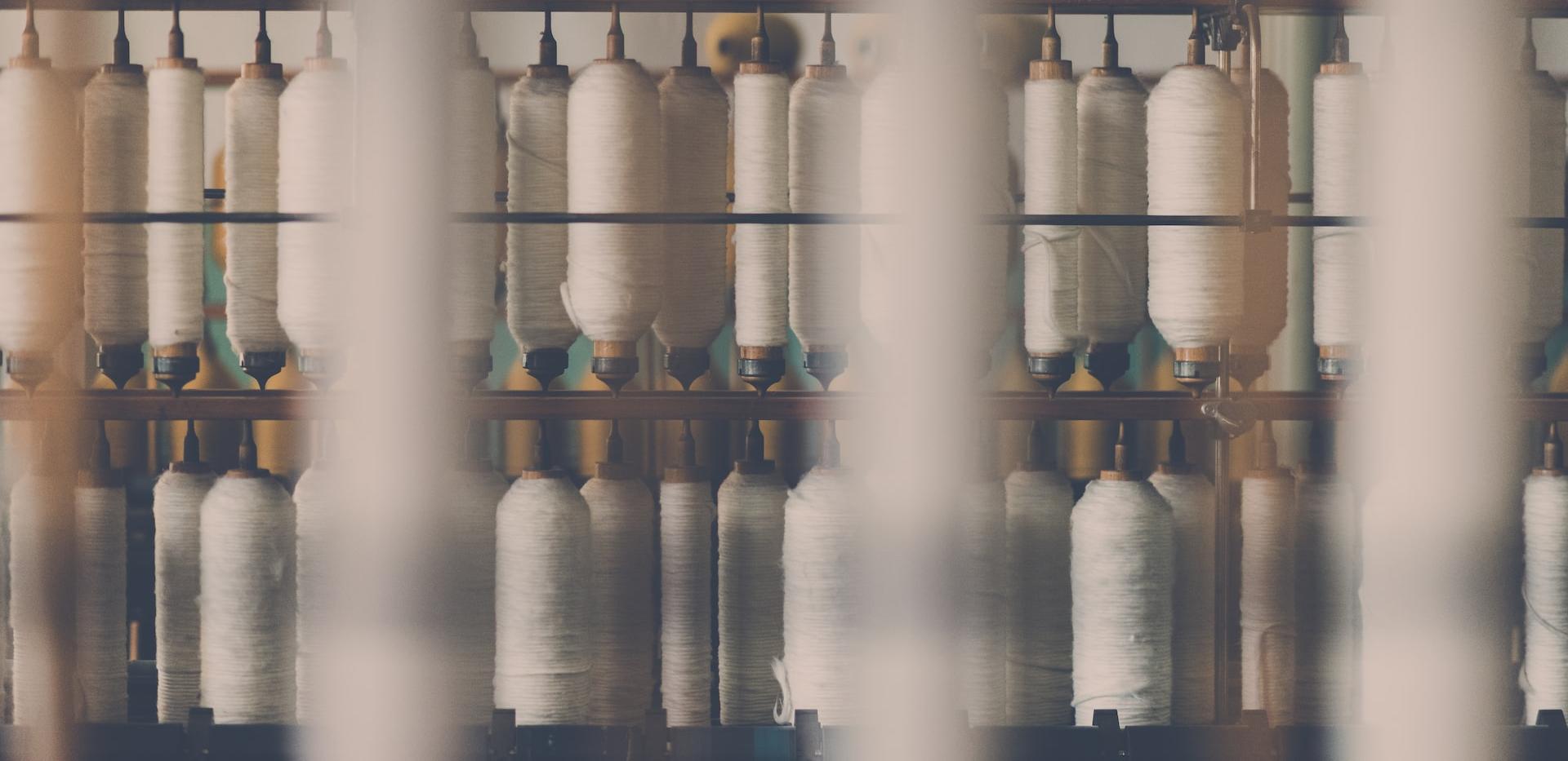 photography of white treadle on brown wooden rack